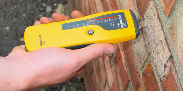 Damp Proofing Service from North West Electrical using a moisture meter