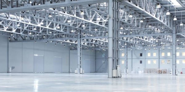 Inside of an industrial unit showcasing a commercial electrical installation from North West Electrical with 80 hanging decorative halogen lamps